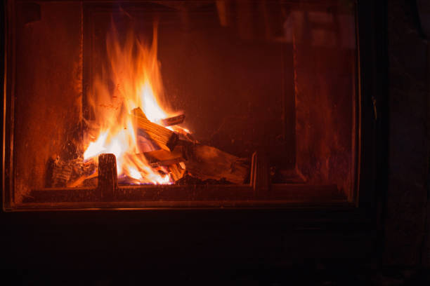 istock dark fireplace with burning wood 1337523341