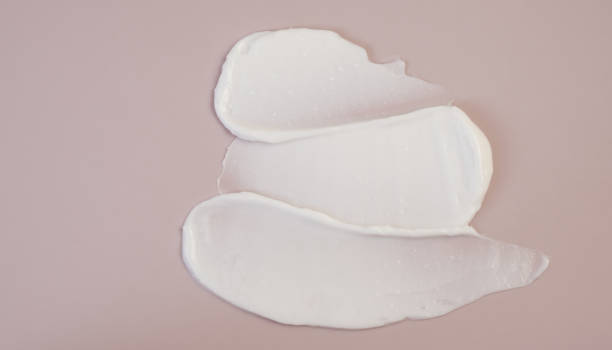 istock White beauty cream lotion highlighter smear swatch smudge on pink background 1337523356