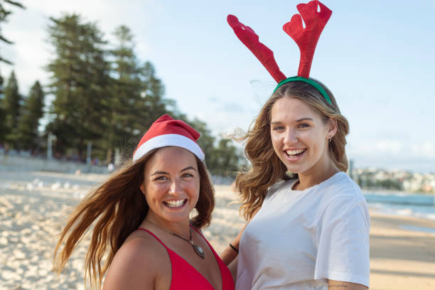 istock Two woman celebrating Christmas at the beach 1337524617