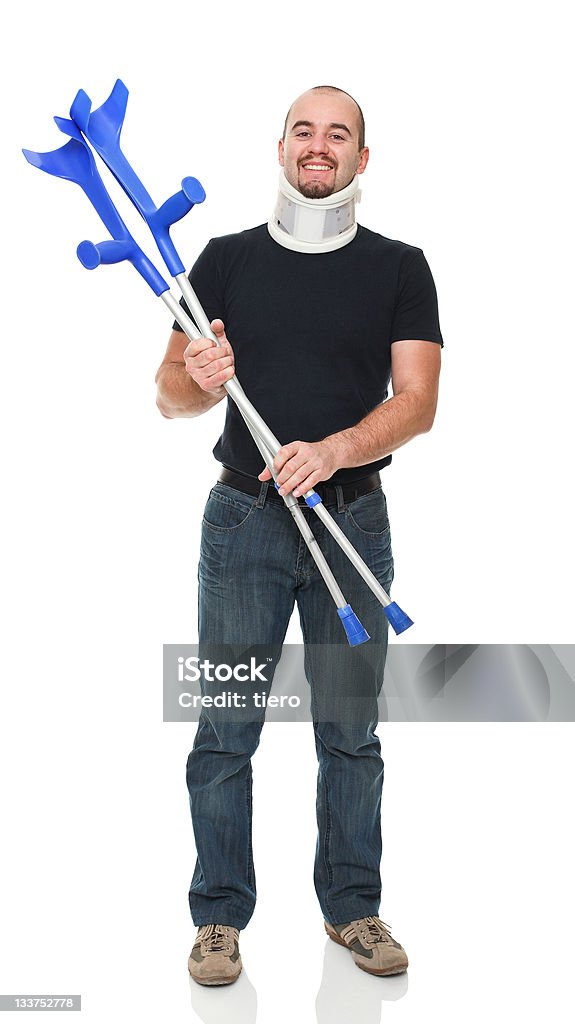 smiling man with crutch smiling man with crutch isolated on white Adult Stock Photo