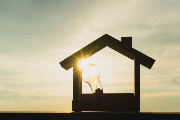 istock Light bulb with wood house on the table, a symbol for construction, Creative light bulb idea, power energy or business idea concept ecology, loan, mortgage, property or home. 1337536297