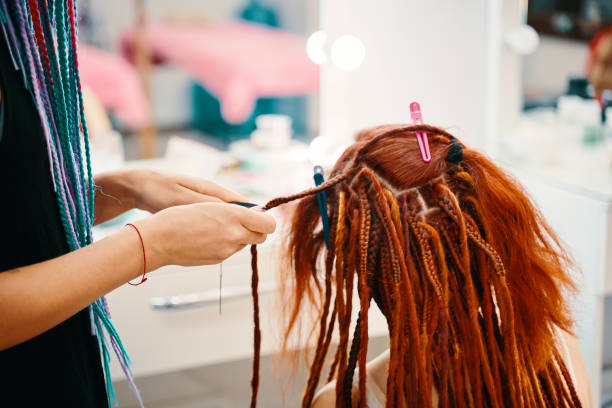 istock Braiding process african plaits with colored kanekalon. 1337537178