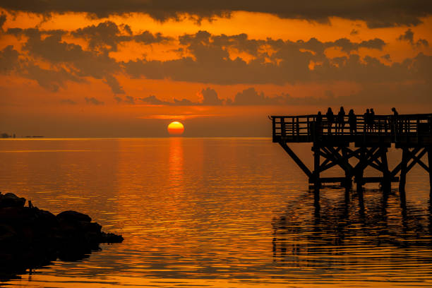 Standing on the pier watching the sunrise on the York River in Yorktown, Virginia.