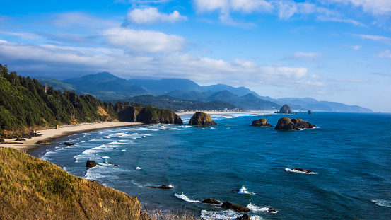 Wide view of waves crashing on shore rocks of Garrapata Beach.\n\nTaken at Garrapata Beach, Big Sur, California, USA