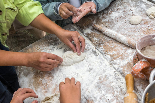 istock A woman teaches children to cook pies with cabbage. 1337549607