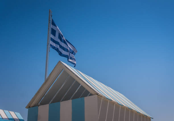istock Greek flag over striped beach hut 1337551381