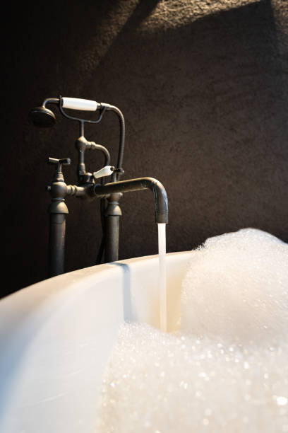 istock Water flowing from vintage designed tap into a bathtub. 1337554805