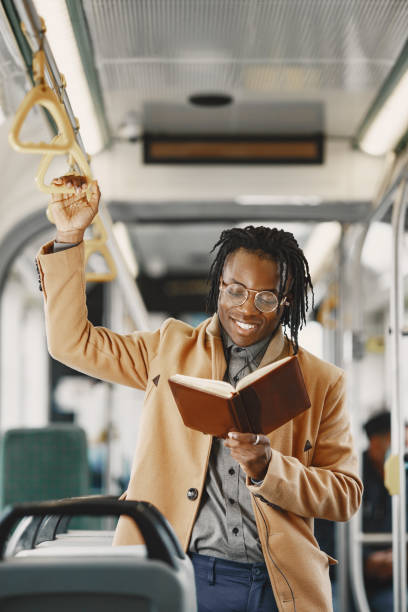 istock Young African businessman standing on a bus 1337555885