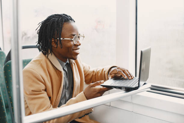 istock Young African businessman standing on a bus 1337555896