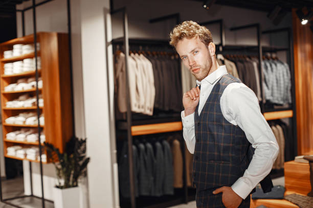 istock Handsome man with beard choosing jacket in a shop 1337556589