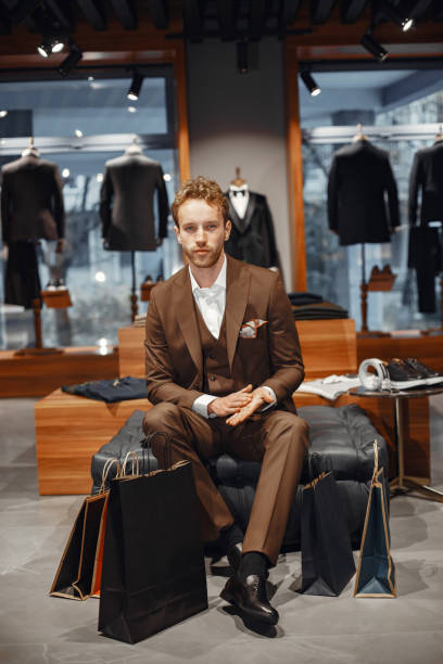 istock Handsome man with beard choosing shoes in a shop 1337556597