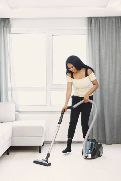 istock African american woman using vacuum cleaner at home 1337558143