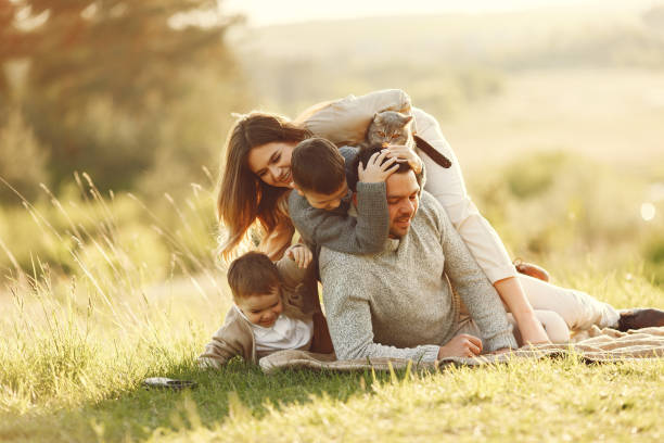 istock Cute family playing in a summer field 1337558234