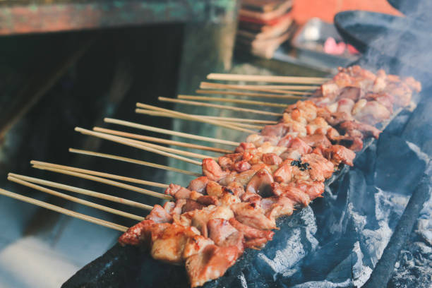 istock Sate Kambing or goat satay on red fire grilling by people. 1337558384