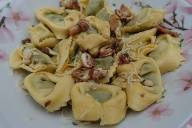 istock Tortelloni stuffed with spinach and cheese served with cooked button mushrooms and pine nuts 1337561174