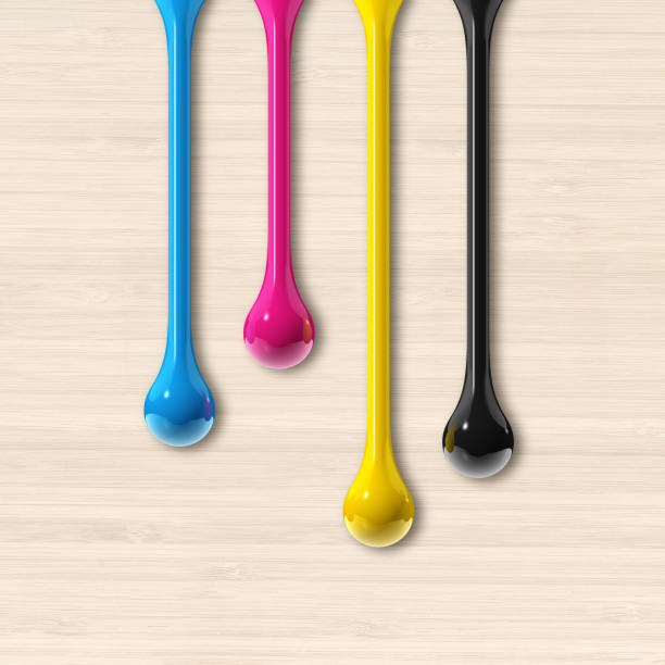 istock cmyk ink drops on beige wooden square background 1337562185