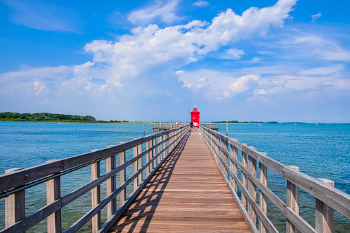 Red lighthouse at Punta Faro in Lignano Sabbiadoro, a summer tourist spot on the Adriatic see coast