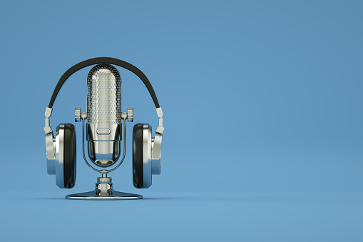 3d rendering of Retro Old Microphone and Headphones, Vintage Style, Blue Color Background.