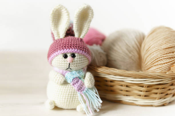 istock Toy knitted on wooden table. Crochet stuffed animals. 1337565247