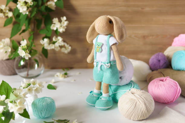 istock Toy knitted on wooden table. Crochet stuffed animals. 1337565262