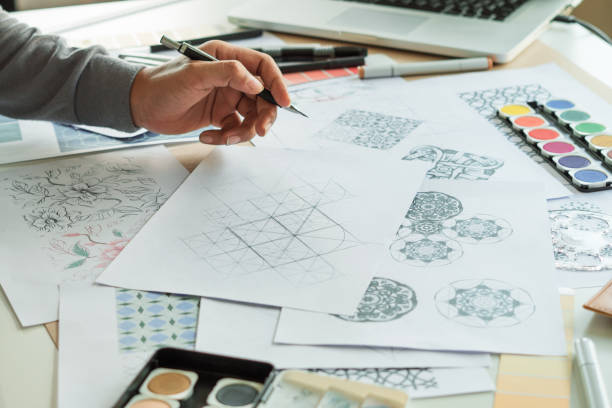istock Designer designing drawing sketch pattern geometric flower seamless wallpaper fabric textile fashion industry. artistic design studio. 1337565563