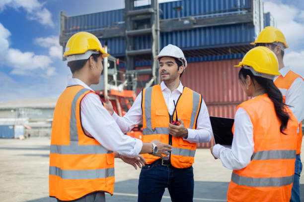 istock Business Logistics concept, Foreman control loading Containers box of cargo freight ship for Logistic planning and explain work to team of diversity 1337566392