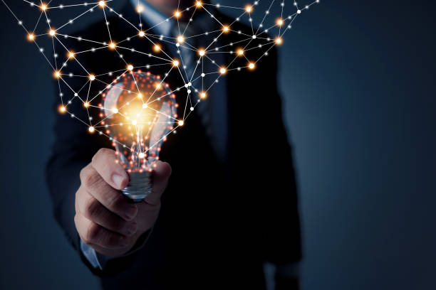 istock Idea and technology innovation concept, businessman holding lighting bulb shining with connection line of power 1337567653