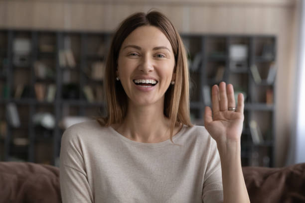 istock Smiling woman looking at camera greeting friend start video call 1337568651