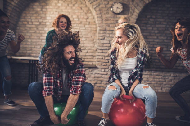 istock Joyful freelance workers having fun in space hopper challenge at casual office. 1337568691