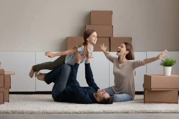 Photo of Happy family having fun at moving day to new house