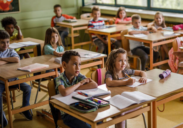 istock Large group of elementary students in the classroom. 1337569981