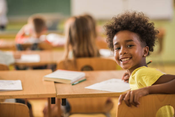 istock Happy African American schoolgirl on a class looking at camera. 1337570825