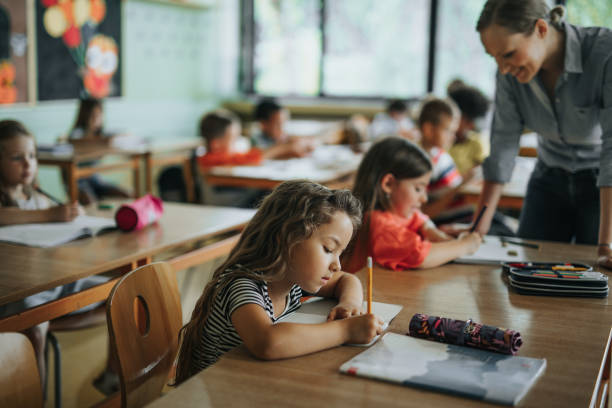 istock Schoolgirl writing a dictation during a class in elementary school. 1337570842
