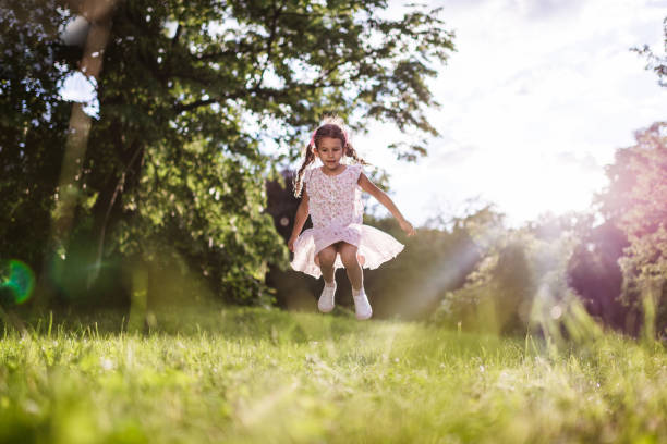 istock Beautiful girl jumping in nature 1337570979