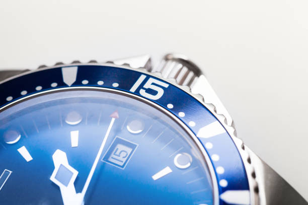 Automatic mechanical mans wrist watch fragment Automatic mechanical mans wrist watch fragment with blue deal, date indication and rotating ceramic bezel, Swiss made. Closeup photo with selective soft focus swiss watches stock pictures, royalty-free photos & images