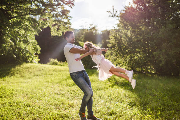 istock Happy father and daughter spinning around at sunset 1337571950