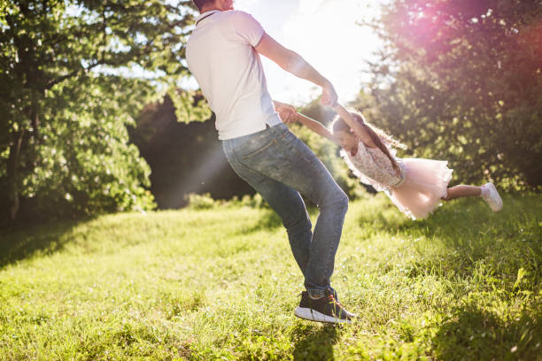 istock Happy father and daughter spinning around at sunset 1337572096