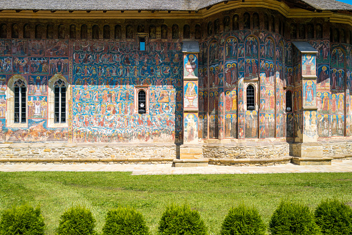 Sucevita, Romania - 5 August, 2021: Color image depicting the ancient architecture and murals of Sucevita monastery in the north of Romania.