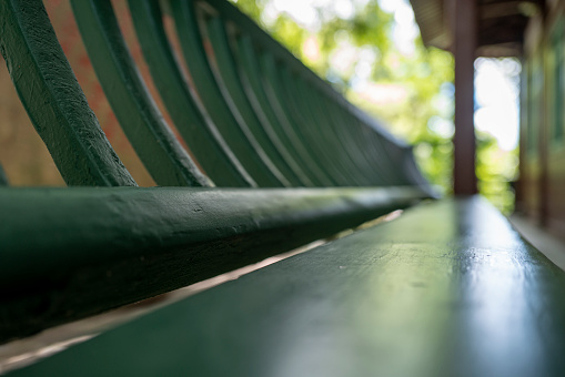 A brown wooden bench in a park