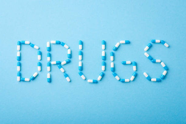 istock Iscription Drugs on blue background 1337578868
