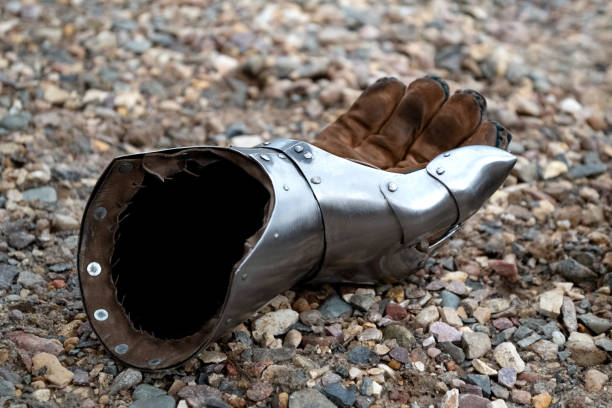 Metallic gauntlet as part of knight equipment abandoned on the ground Metallic gauntlet as part of knight equipment abandoned on the ground chivalry stock pictures, royalty-free photos & images