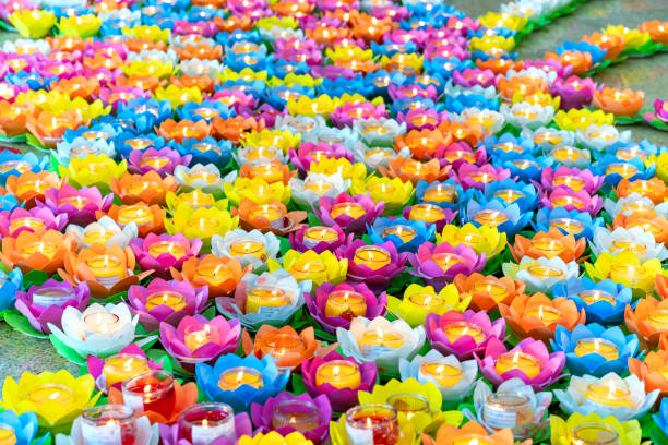 colorful ornate candles are lit in the temple yard to celebrate buddha's birthday - vesak day 個照片及圖片檔