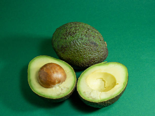 istock Fresh organic avocado on a green background. 1337584954