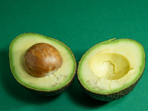 istock Fresh organic avocado on a green background. 1337584956