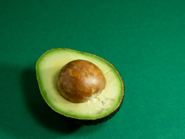 istock Fresh organic avocado on a green background. 1337584957