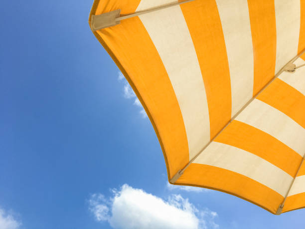 istock Yellow umbrella on the beach 1337587431