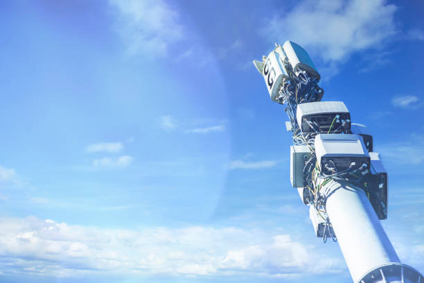 Cell tower against the blue sky. A pillar with transmitters, repeaters and antennas for mobile communications and the Internet.