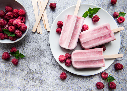Homemade raspberry ice cream and fresh raspberries. Summer food.