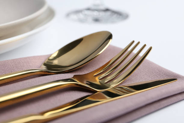 istock Stylish elegant cutlery set with napkin on white table, closeup 1337595333