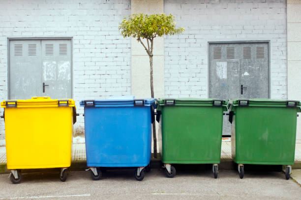 ряд разноцветных мусорных баков у тротуара для переработки. - multi colored paper color image garbage стоковые фото и изображения